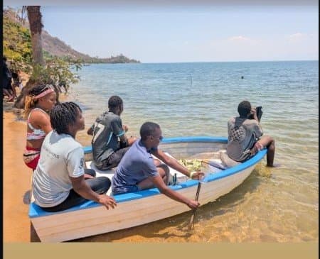 Group paddling a boat on Lake Malawi